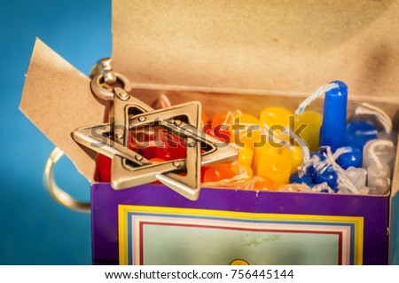 A box with colorful Hanukkah candles. Hanukkah is a Jewish holiday of light that falls usually on December and sometimes coincides with Christmas. Hanukkah candles, Hanukkah concept image.