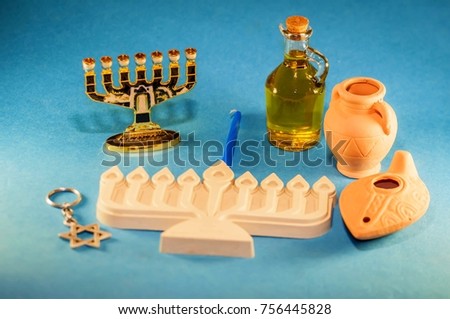 A Hanukkah concept composition: clay menorah, metal menorah, clay pots and lamps, a jar with oil, David Star. Hanukkah is the Jewish festival of light.
