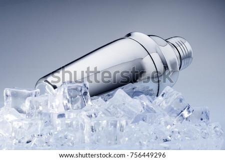 metal cokctelera on ice cubes