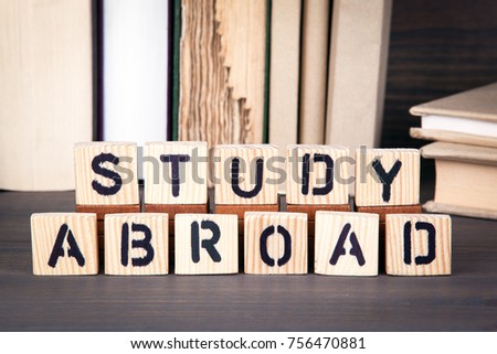 study abroad, wooden letters on wooden table. Education, success and communication background