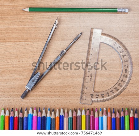 School tools for geometry. Compas with protractor and pencils