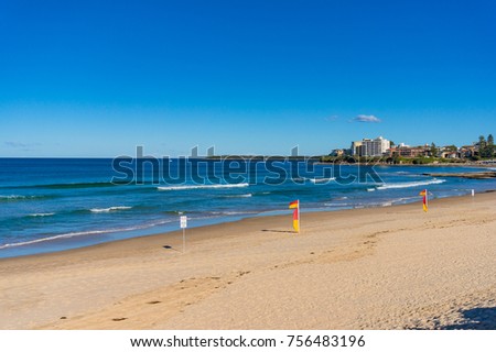 Beach with safe for swimming flags on sunny day. Summer holiday background