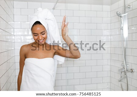 Young woman in white towels wrapped around head and body after shower Royalty-Free Stock Photo #756485125
