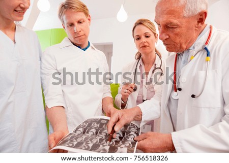 Doctors studying CAT scan