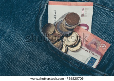 Money euro in Denim pants pocket. Money saving concept.
