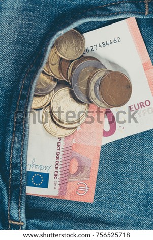 Money euro in Denim pants pocket. Money saving concept.