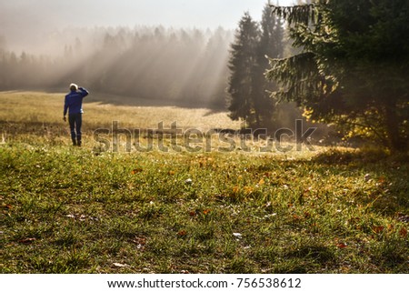 Man walking in beautiful autumn morning. Adventure, travel photo