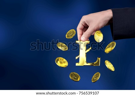 Currency litecoin gold symbols in a man hand