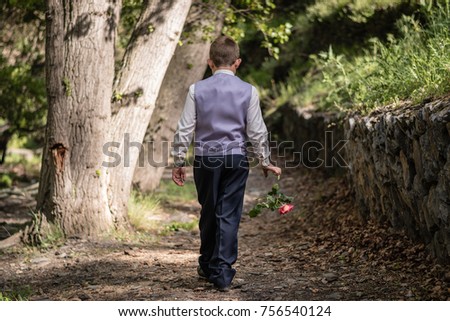 First comunion pictures for a young boy. He was holding a rose while walking and then letting it fall on the ground.