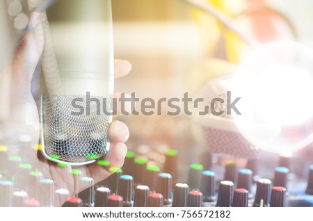 men hand holding a single retro microphone against brown background,double exposure style