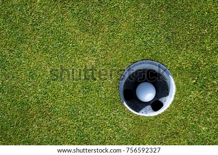 Golf green with golf ball in the hole
 Royalty-Free Stock Photo #756592327