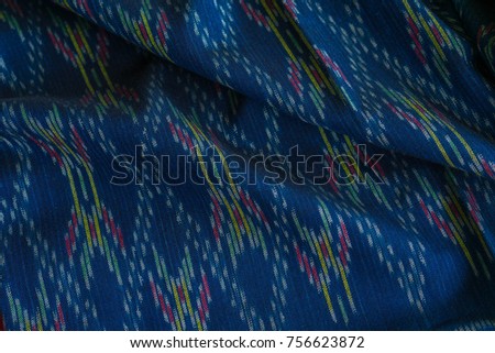 Ikat fabric. thai color blue silk. Pattern on my ikat silk piece. Silk is a natural protein fiber. Tough and glossy. color of dyed silk from natural materials. Is a delicate craft. Uthai Thani, Thail
