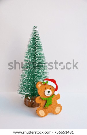 Merry Christmas greeting card with bear and christmas tree on white background.