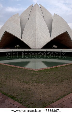 Delhi, India - March 4, 2011: Futuristic picture of lotus shaped part of the Baha'i temple. Reflection in one of the adjacent pools.