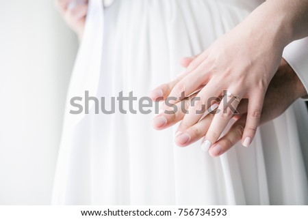 the hands of moms and dads waiting for a baby wedding