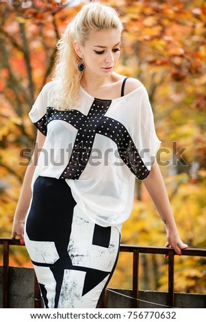 Beautiful Woman in dress and old arhitecture on Fall Nature Background