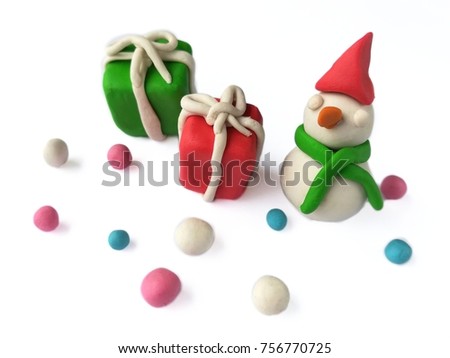 Beautiful plasticine clay made are colorful snow falling with snowman, red and green gift box on white background, atmosphere are happiness,Merry Christmas dough