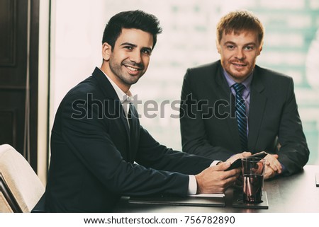 Two Young Businessmen in Meeting Room