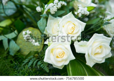 bouquet of white roses, yellow daffodils, greenery and lotuses