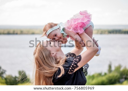 Mom kisses little daughter