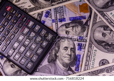 Modern calculator on one hundred dollar bills