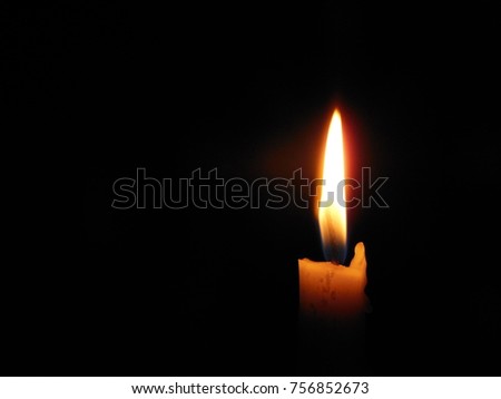 Candle flame closeup black background space for message or icon