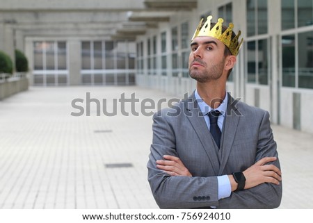 Arrogant businessman with a crown in office space Royalty-Free Stock Photo #756924010