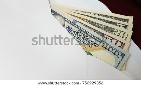 American dollar banknotes in the white envelope