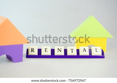 Rental concept using colorful board built as a house using white background. Selective focused.