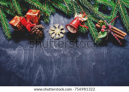 Christmas tree and Christmas tree decorations on black wooden surface. Christmas background. Top view with copy space. Preparation for holidays. Toned