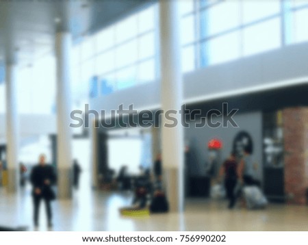 Blurry, out of focus and bokeh photo of people walking inside Airport
hall.
