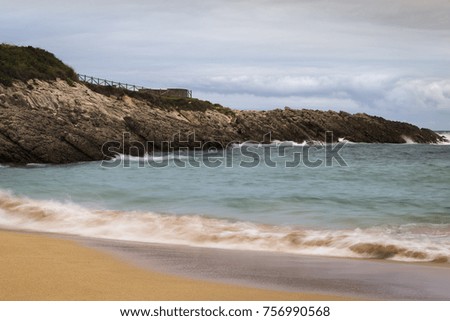 beautiful beach with waves breaking on the shore and without people
