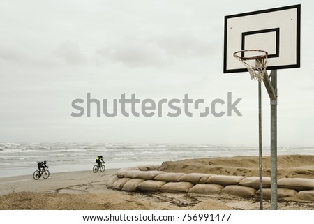 Winter day in the beach, old basketball board with hoop net