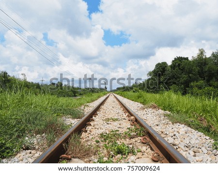 Train railway track in a rural countryside village scene with blue sky and beautiful cloudy.