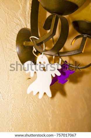 Halloween decoration on the wall ,pumpkin , ghost ,black ,funny ,white ,hanged ,ornament ,decor ,scary ,smiling ,interior