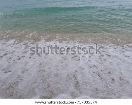 White sand beach with blue sea.  the beach at the seaside has a white sand , blue sky and clear water