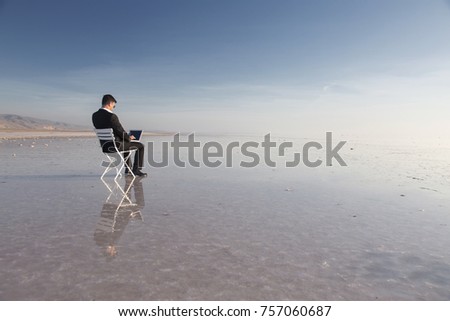 Business man with laptop working on the beach.Freelancer, happy successful businessman on the beach