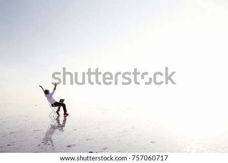 Business man with laptop working on the beach.Freelancer, happy successful businessman on the beach
