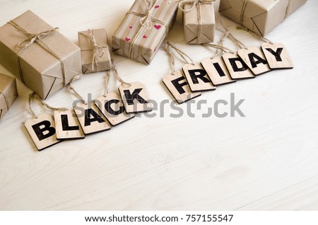 black Friday discounts. An inscription on a black, white, wooden background. Gift with a discount