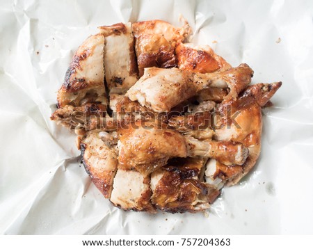 Chopped grilled chicken Thai style on white grease-proof paper Royalty-Free Stock Photo #757204363