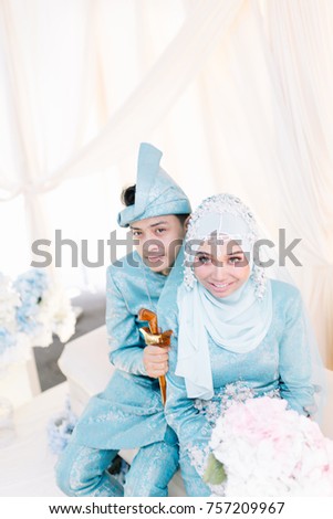 Portrait of young couple. Love story of handsome man and beautiful woman in Malay or Asian traditional dress.