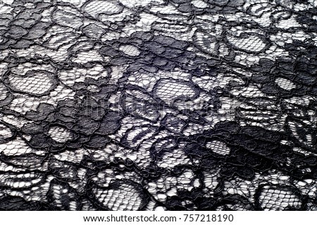 Texture, background, pattern. Fabric of black lace. Background of fabric from lace stylized roses. Abstract lace pattern with flowers. Wallpaper, underwear and jewelry. Your invitations