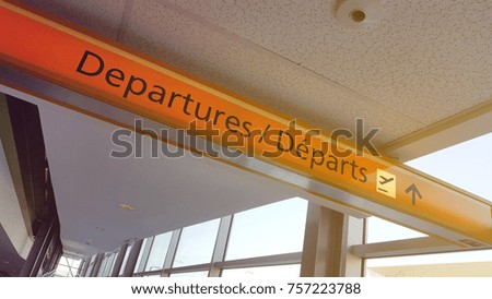 Yellow departure sign in airport terminal