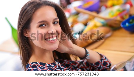 Group of people having dinner together while sitting at wooden table