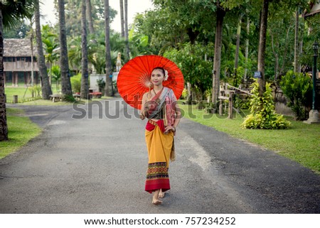 Asian woman wearing Traditional Costume painting umbrella,Lanna style northern chiangmai Thailand