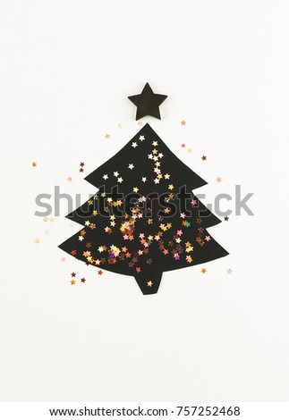 New Year tree of black color made from paper and glitter on a white background