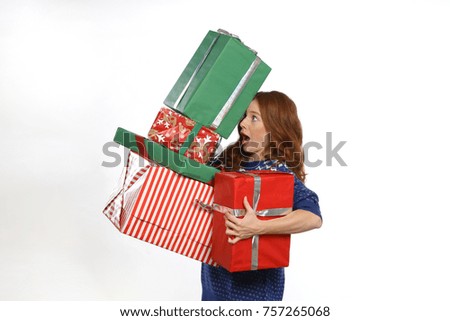Beautiful redhead woman balance with presents in her hand 