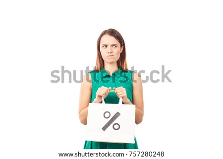 Portrait of female shopaholic holding shopping bags with sale/discount sign