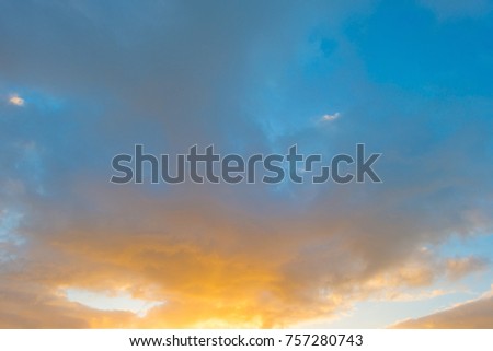 Clouds in a blue sky at sunrise in autumn