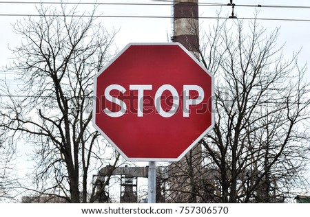 Red Stop Sign on the background of the factory
